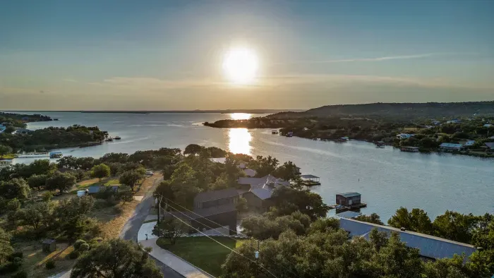 Panoramic sunset view of the lake and rolling hills.