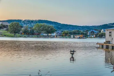 Peaceful lake view with calm waters and scenic hills.