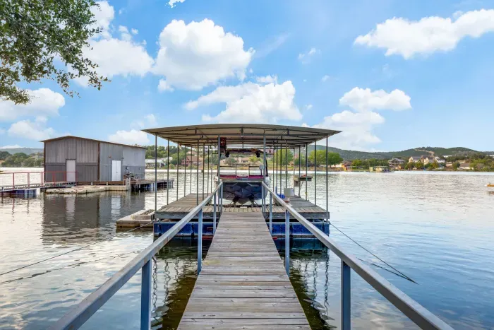 Private dock and infinity pool overlooking scenic lake views.