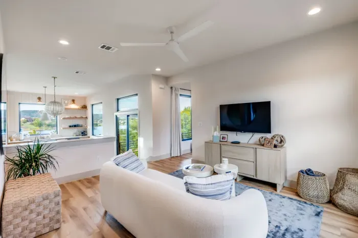 Open-concept living room with lake views and cozy seating.