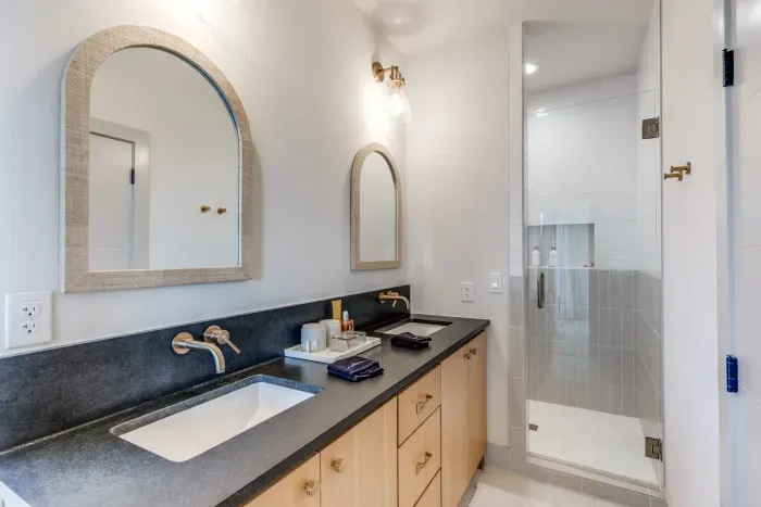 Spa-style bathroom with dual sinks and walk-in shower.
