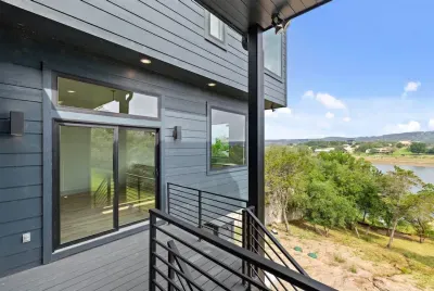 Back balcony with views of the lake and surrounding hills.