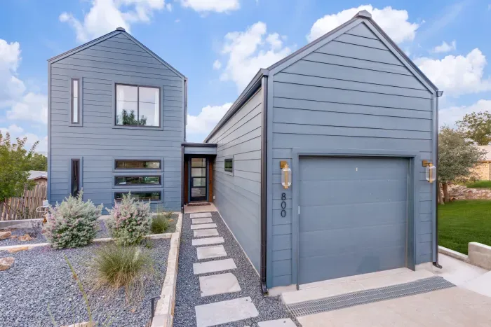 Modern exterior with spacious driveway and garage.