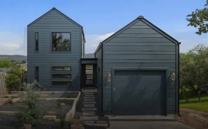 Modern front exterior with sleek design and private driveway.