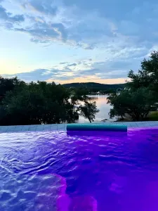 Stunning pool view with colorful evening lighting.
