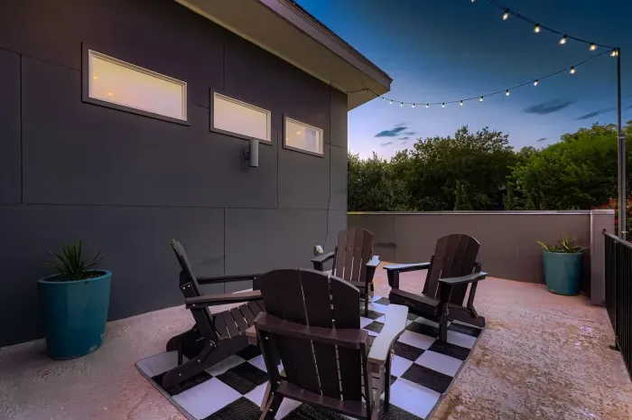 Nighttime balcony with bistro lights for a warm, inviting glow.