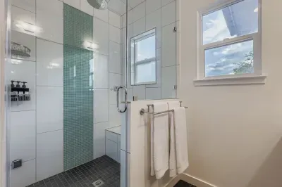 Glass shower with rainfall head and spa-inspired feel.