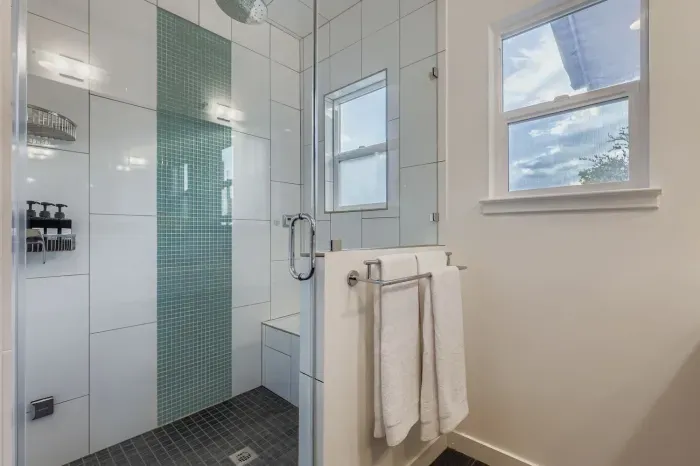 Glass shower with rainfall head and spa-inspired feel.