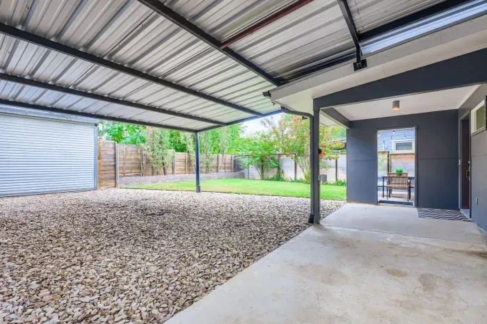 Covered carport area for shade and convenience.