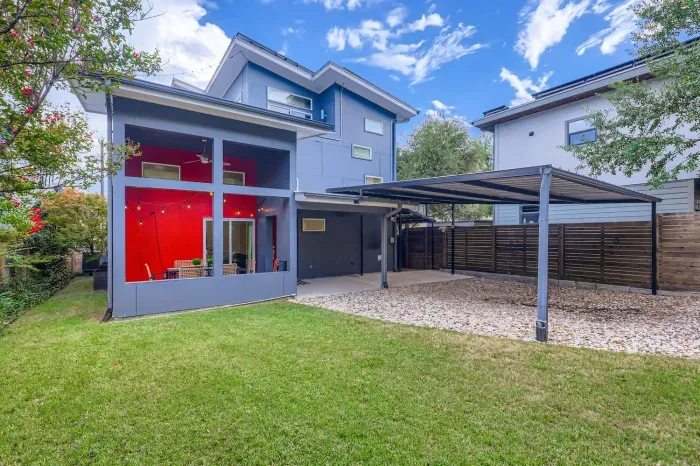 Spacious backyard with modern home design and plenty of room to play.