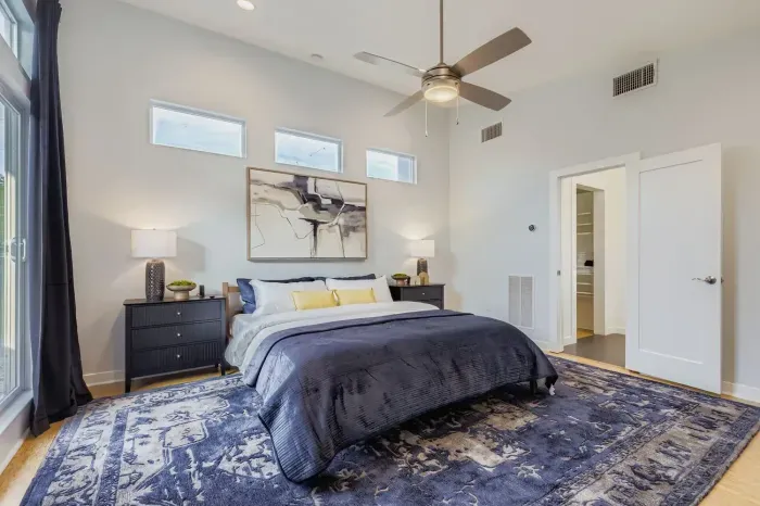 Cozy corner bedroom with plush rug and elegant design.