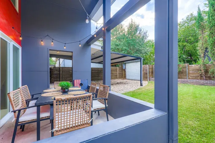 Cozy outdoor dining nook with string lights for evening meals.