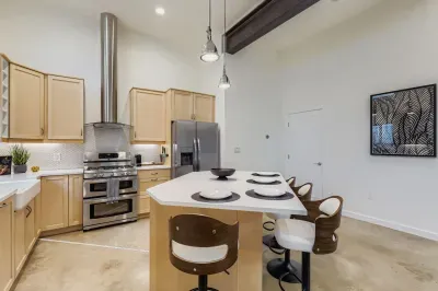 Fully equipped kitchen with modern appliances and dining for six.