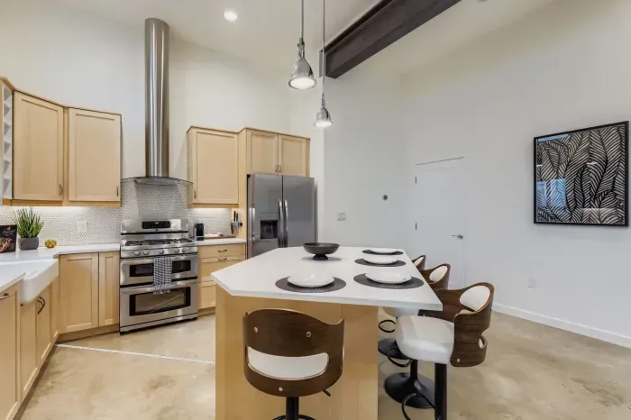 Fully equipped kitchen with modern appliances and dining for six.