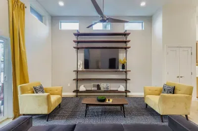 Entertainment wall with large flat-screen TV and bold modern accents.