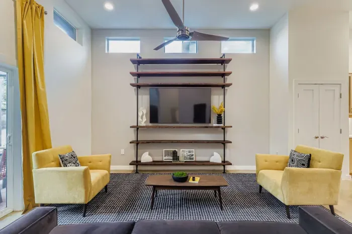 Entertainment wall with large flat-screen TV and bold modern accents.