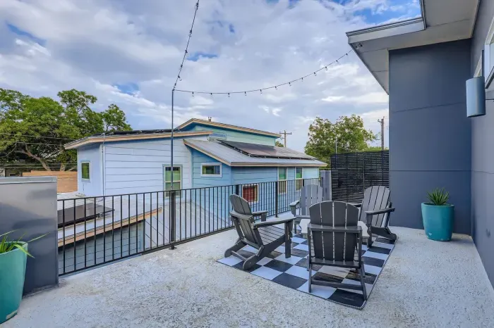 Sunny outdoor balcony with seating. Perfect for morning coffee.