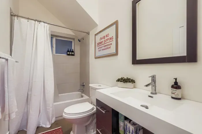 Bright bathroom with walk-in shower and modern fixtures.