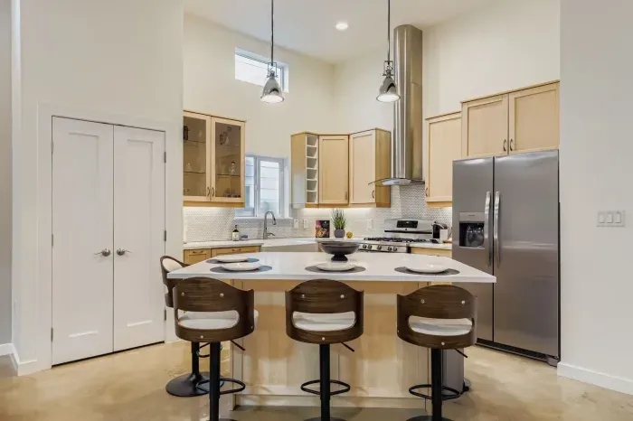 Sleek kitchen design with bar seating for casual meals or morning coffee.