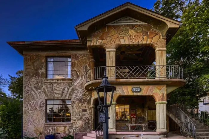 This stunning architectural gem features an intricately designed balcony that offers charming views of the surrounding area. The stone facade, detailed craftsmanship, and unique patterns add a rustic charm, making it a perfect spot to enjoy the seren