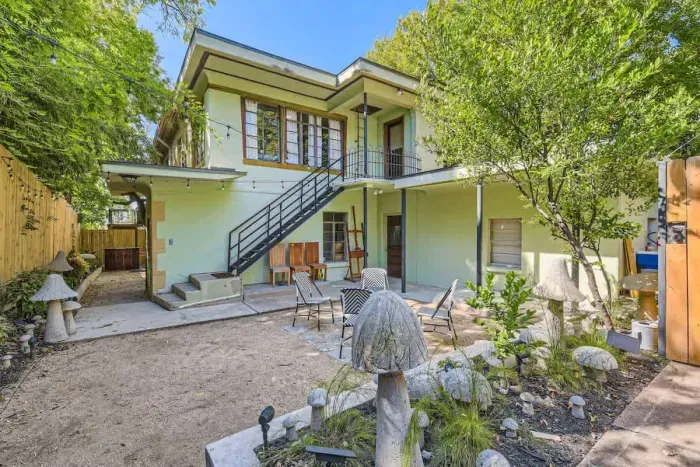 Relax in a private courtyard, a serene outdoor space surrounded by beautiful architecture. Perfect for unwinding, with lush plants, cozy seating, and peaceful ambiance. Your peaceful retreat awaits!