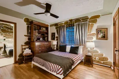 Comfortable bedroom with hardwood floors.