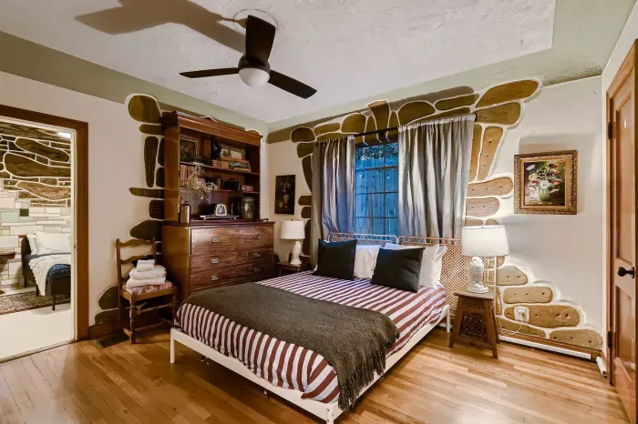 Comfortable bedroom with hardwood floors.