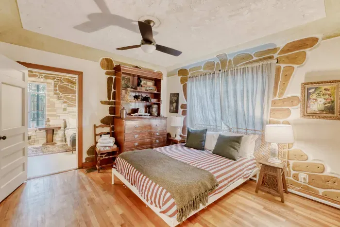 Comfortable bedroom with hardwood floors.