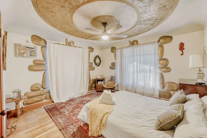 Cozy bedroom with unique artistic details.