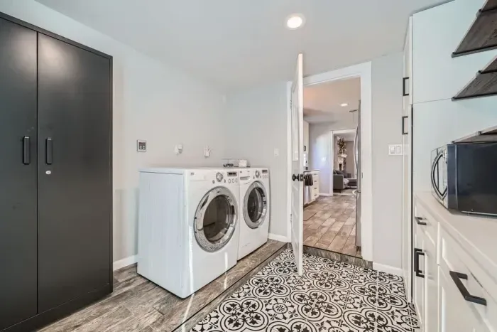 Convenient laundry room with modern appliances and plenty of counter space for folding.