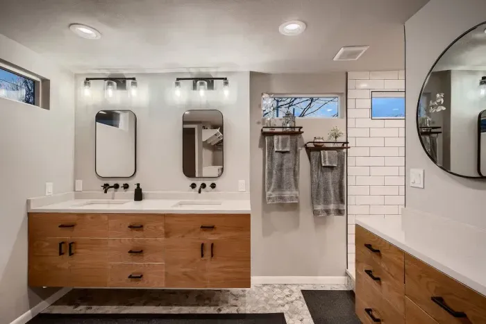 Spacious bathroom with dual sinks and a large mirror for added convenience