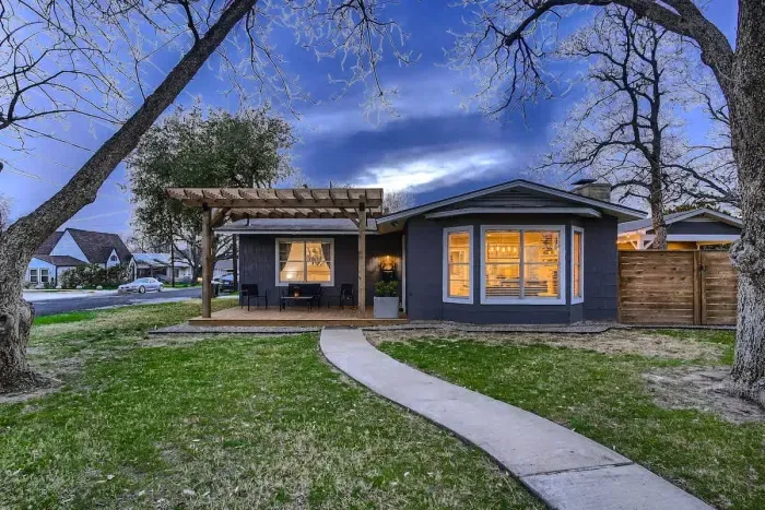Charming exterior with a welcoming front porch and beautifully landscaped yard.