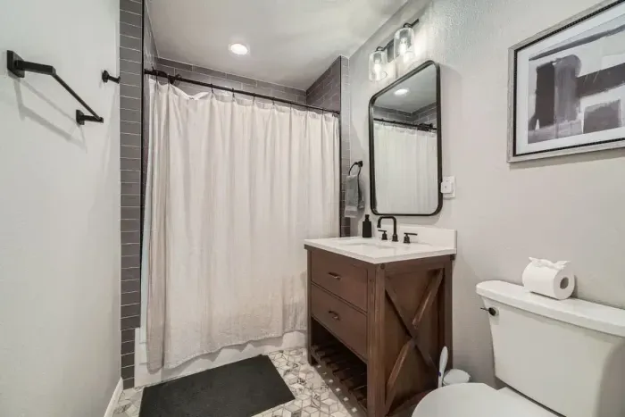 A refreshing, clean bathroom with charming decor and all the essentials.