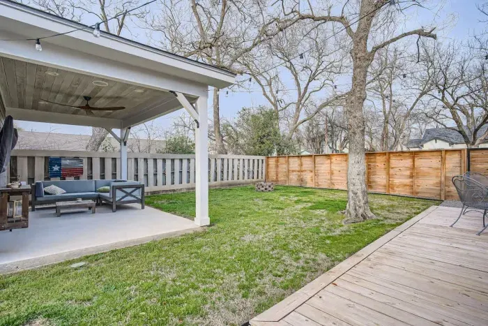 Step into the spacious backyard, featuring a covered patio perfect for outdoor dining or relaxation. The patio provides shade and comfort, while the surrounding yard offers plenty of space for activities and enjoyment.