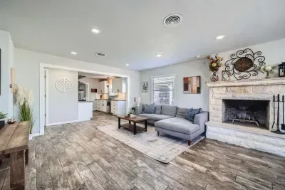 Beautifully integrated living room and dining space designed for comfort and functionality. This cohesive area allows for seamless entertaining and family gatherings, with ample natural light enhancing the ambiance.