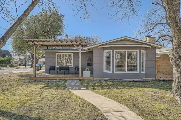 Welcoming entrance with charming curb appeal and lush landscaping.