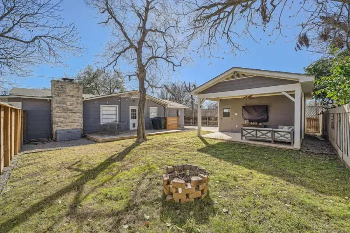 Private backyard oasis featuring a large deck, comfy seating, and a fire pit for cozy evenings.