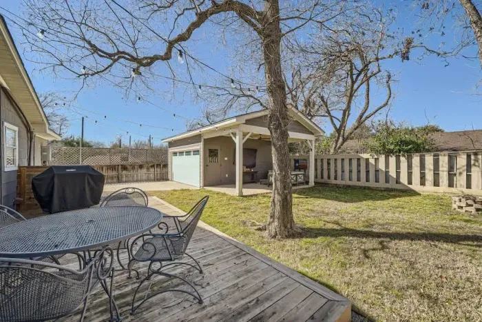 Spacious backyard with a lush lawn, perfect for outdoor games, relaxation, and barbecues.