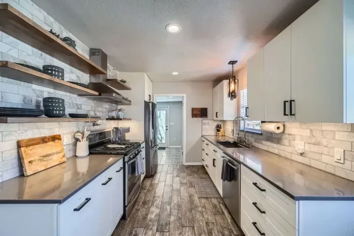 Bright and modern kitchen with stainless steel appliances, perfect for preparing a gourmet meal or quick snacks.