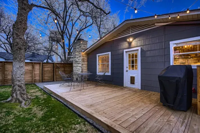 Spacious backyard with a lush lawn, perfect for outdoor games, relaxation, and barbecues.