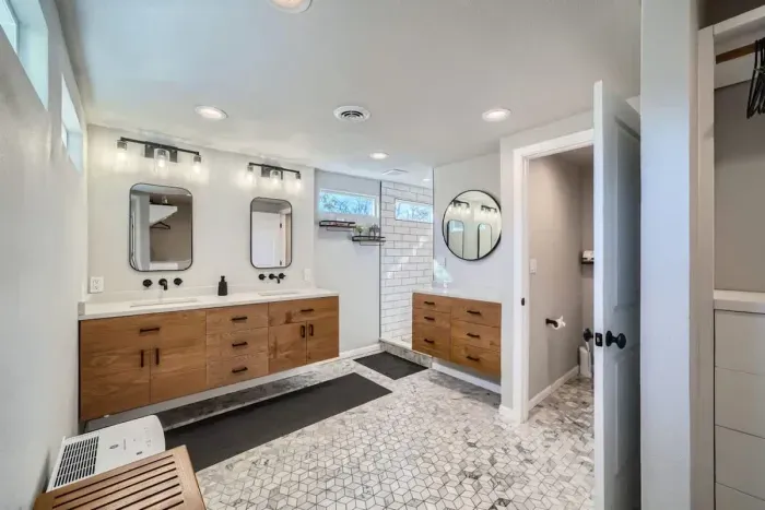 Spacious bathroom with dual sinks and a large mirror for added convenience
