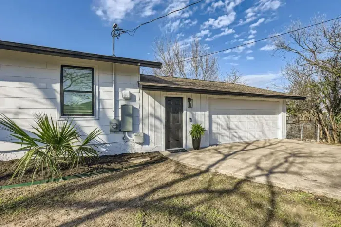 Welcoming entrance with charming curb appeal and lush landscaping.