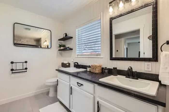 Spacious bathroom with dual sinks and a large mirror for added convenience.