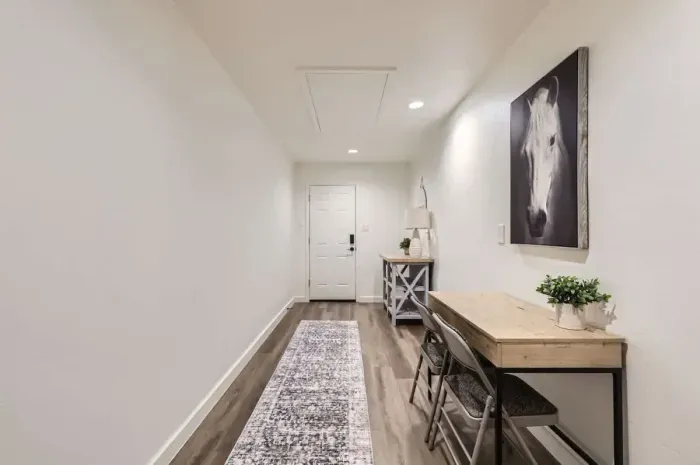 Step into a bright and welcoming entryway featuring modern décor and cozy workspaces.