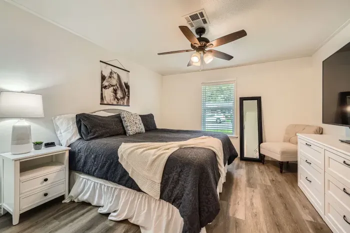 Comfortable bedroom with soft bedding and natural light.