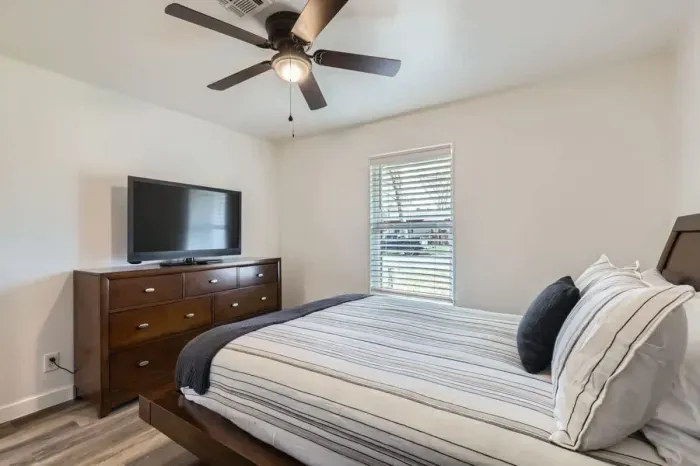 Modern bedroom with minimalist design and high-quality bedding.