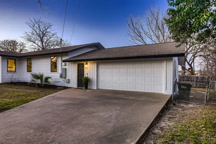 Welcoming entrance with charming curb appeal and lush landscaping.