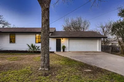 Welcoming entrance with charming curb appeal and lush landscaping.