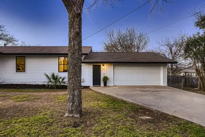 Welcoming entrance with charming curb appeal and lush landscaping.