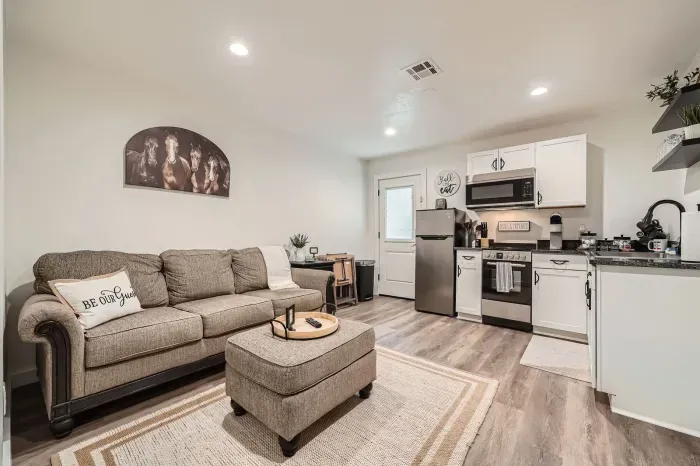 Open living room with plenty of seating and a connected kitchen.